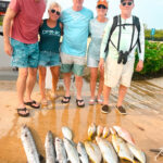 guests with their catch after a day of fishing in belize