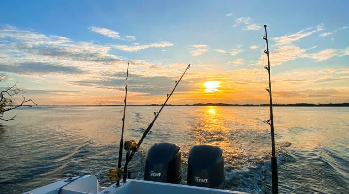 Colorful fishing boat at sunset in Belize, perfect for reef and offshore adventures and Belize reef snorkeling excursions.