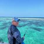 A guest fishing on the beautiful belize barrier reef